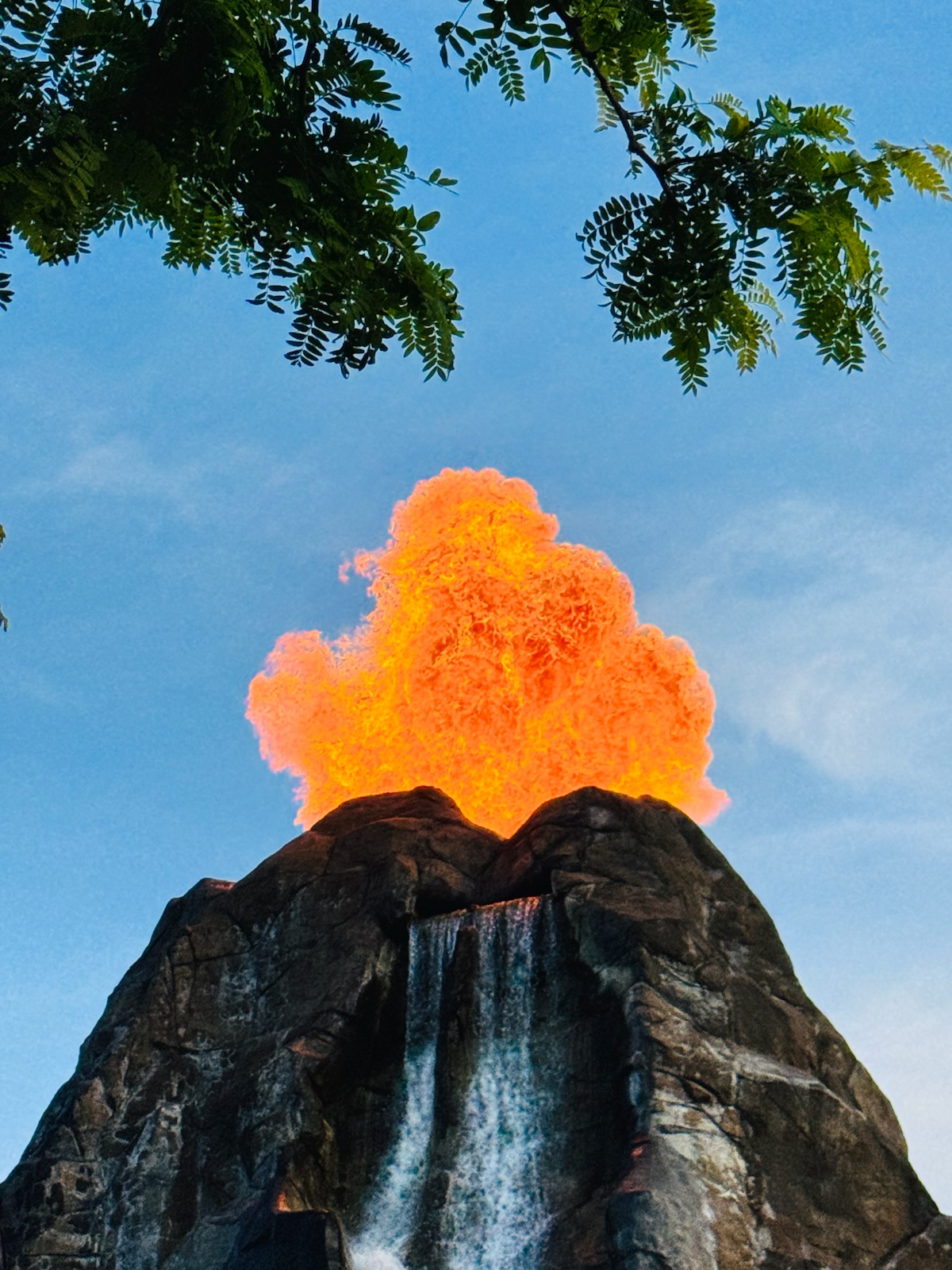 A burst of fire erupting from the top of a rock peak